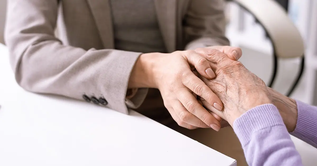 Mulher idosa analisando opções de financiamento com apoio financeiro