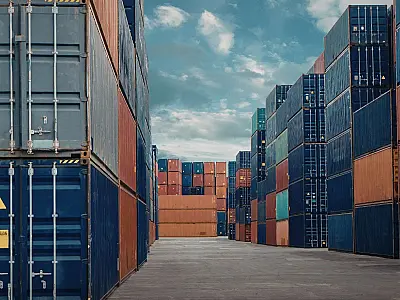 Contêineres organizados em terminal portuário semelhante ao Porto de Santos.