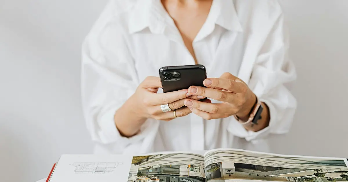 Pessoa utilizando celular para acessar redes sociais.