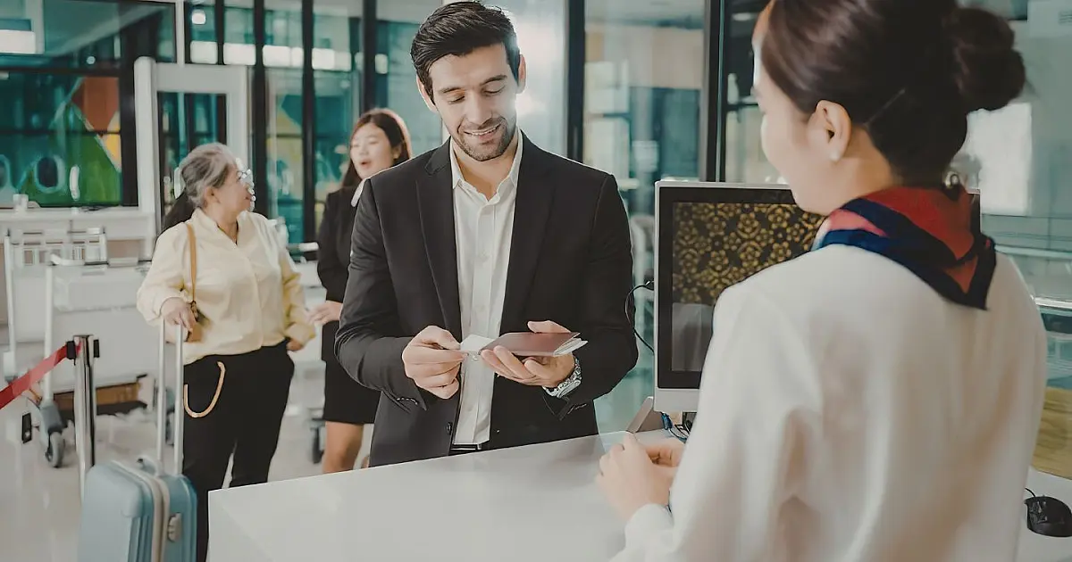 Hóspede realizando check-in digital em balcão de atendimento