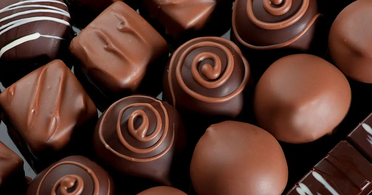 Tabletes de chocolate exibidos lado a lado representando mudanças nas regras sobre percentual de cacau no Brasil.